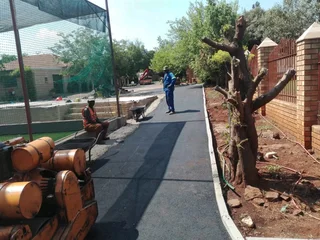 Tar surfacing and brick paving