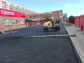 Tar surfacing and brick paving