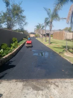 Tar surfacing and brick paving