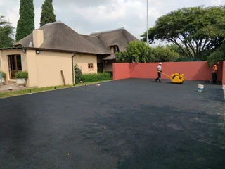 Tar surfacing and brick paving