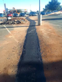 Tar surfacing and brick paving