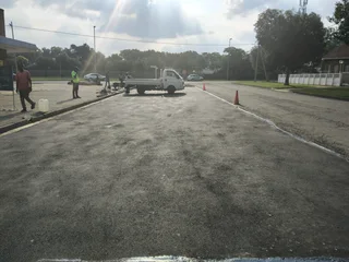 Tar surfacing and brick paving