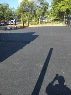 Tar surfacing and brick paving