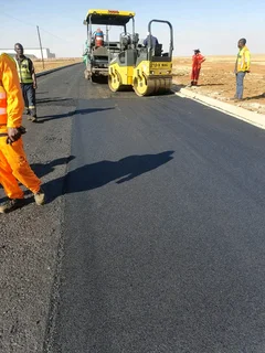 Tar surfacing and brick paving