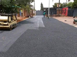 Tar surfacing and brick paving