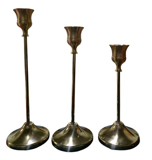 Set of three graduated brass taper candlesticks