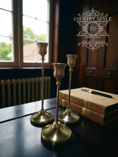 Set of three graduated brass taper candlesticks