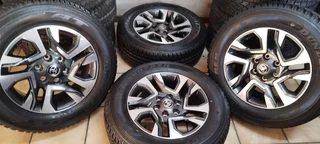 18inch Toyota Fortuner original mags with brand new 265/60/18 Dunlop Grandtrek A/T set R17500.