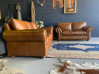 A stunning 2 piece STUDIO STYLE genuine leather lounge suite. (3 &amp; 2 SEATER) Brand new.