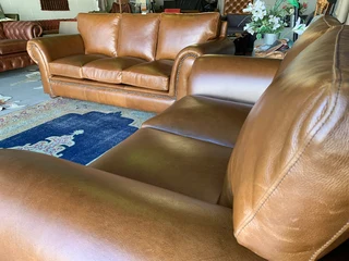 A stunning 2 piece STUDIO STYLE genuine leather lounge suite. (3 &amp; 2 SEATER) Brand new.