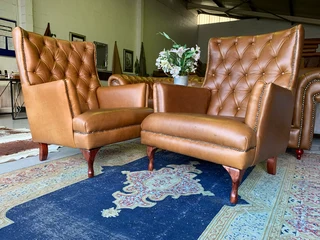 2 x Occasional genuine leather DESIGNER WINGBACK ARMCHIARS plus 2 x footstool ottomans.  R13500 each