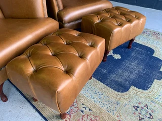 2 x Occasional genuine leather DESIGNER WINGBACK ARMCHIARS plus 2 x footstool ottomans.  R13500 each