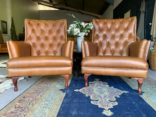 2 x Occasional genuine leather DESIGNER WINGBACK ARMCHIARS plus 2 x footstool ottomans.  R13500 each