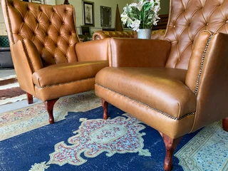 2 x Occasional genuine leather DESIGNER WINGBACK ARMCHIARS plus 2 x footstool ottomans.  R13500 each