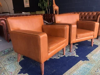 Brand new gameskin genuine leather  MID-CENTURY armchairs. (A modern streamline design) R6500 each .