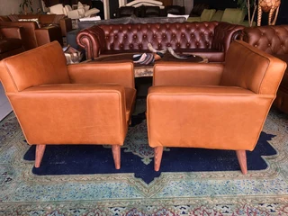 Brand new gameskin genuine leather  MID-CENTURY armchairs. (A modern streamline design) R6500 each .