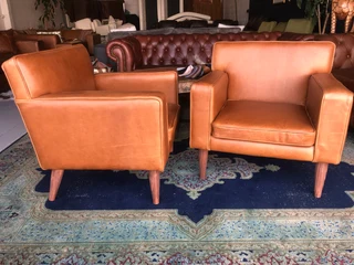 Brand new gameskin genuine leather  MID-CENTURY armchairs. (A modern streamline design) R6500 each .
