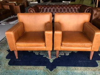 Brand new gameskin genuine leather  MID-CENTURY armchairs. (A modern streamline design) R6500 each .