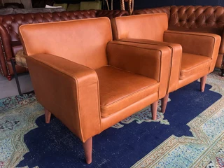 Brand new gameskin genuine leather  MID-CENTURY armchairs. (A modern streamline design) R6500 each .