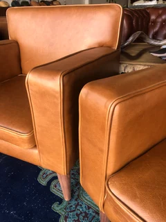 Brand new gameskin genuine leather  MID-CENTURY armchairs. (A modern streamline design) R6500 each .