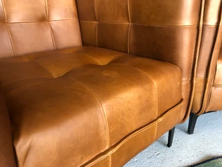 2 x Brand new CONTEMPORARY DESIGN genuine leather armchairs. (TUFFED STITCH DETAILING) R9995 each.