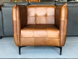 2 x Brand new CONTEMPORARY DESIGN genuine leather armchairs. (TUFFED STITCH DETAILING) R9995 each.