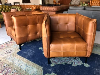 2 x Brand new CONTEMPORARY DESIGN genuine leather armchairs. (TUFFED STITCH DETAILING) R9995 each.