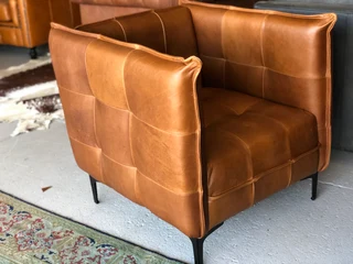 2 x Brand new CONTEMPORARY DESIGN genuine leather armchairs. (TUFFED STITCH DETAILING) R9995 each.