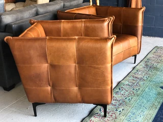 2 x Brand new CONTEMPORARY DESIGN genuine leather armchairs. (TUFFED STITCH DETAILING) R9995 each.