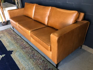 Immaculate 2.2m gameskin genuine leather large three seater couch. (A MODERN SLIMLINE DESIGN)