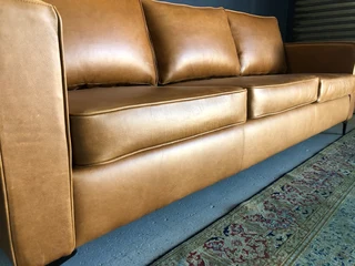 Immaculate 2.2m gameskin genuine leather large three seater couch. (A MODERN SLIMLINE DESIGN)