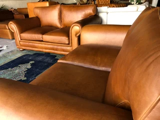 Newly manufactured 2pc  GATES TO AFRICA DESIGN genuine leather lounge suite. (2 x 1.8m TWO SEATERS)
