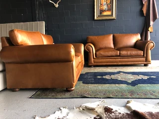 Newly manufactured 2pc  GATES TO AFRICA DESIGN genuine leather lounge suite. (2 x 1.8m TWO SEATERS)