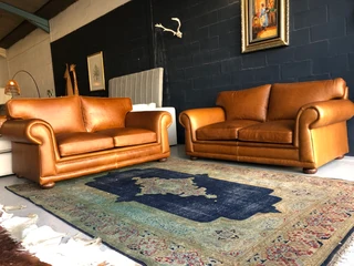 Newly manufactured 2pc  GATES TO AFRICA DESIGN genuine leather lounge suite. (2 x 1.8m TWO SEATERS)