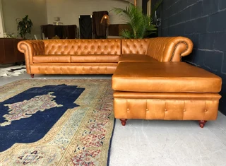 A classic 3m x 2m genuine leather Chesterfield L-shape corner lounge suite plus 1m modular ottoman.