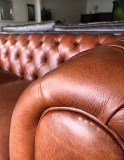 A elegant 1.8m  genuine leather CHESTERFIELD two seater sofa. Brand new. (WITH PIPING DETAILING)