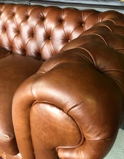 A elegant 1.8m  genuine leather CHESTERFIELD two seater sofa. Brand new. (WITH PIPING DETAILING)