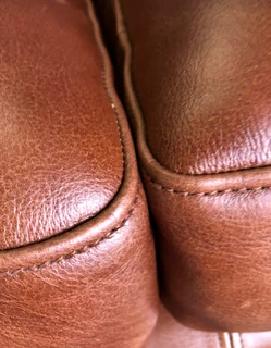 A elegant 1.8m  genuine leather CHESTERFIELD two seater sofa. Brand new. (WITH PIPING DETAILING)