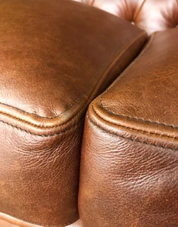 A elegant 1.8m  genuine leather CHESTERFIELD two seater sofa. Brand new. (WITH PIPING DETAILING)