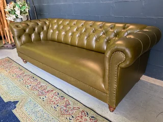 A classic 2.1m olive green genuine leather Chesterfield three seater sofa. (A VINTAGE COLLECTION)