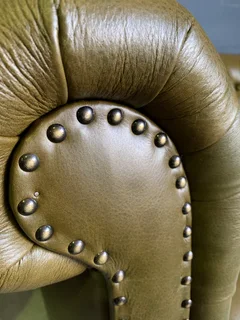 A classic 2.1m olive green genuine leather Chesterfield three seater sofa. (A VINTAGE COLLECTION)