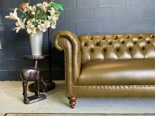 A classic 2.1m olive green genuine leather Chesterfield three seater sofa. (A VINTAGE COLLECTION)