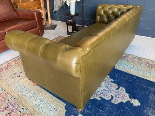 A classic 2.1m olive green genuine leather Chesterfield three seater sofa. (A VINTAGE COLLECTION)