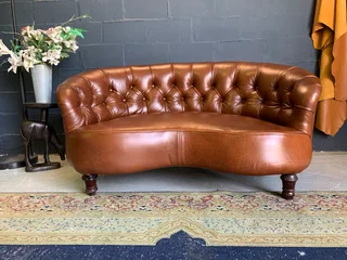 A elegant 1.3m FRENCH STYLE genuine leather deep buttoned two seater lsofa. (A VINTAGE COLLECTION)