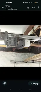 Garage door motor including track and screw