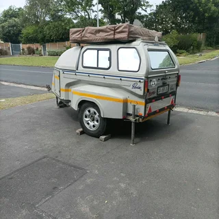 Camping trailer with roof top tent, in good condition, sleeps 2 adults in tent and 2 in trailer.