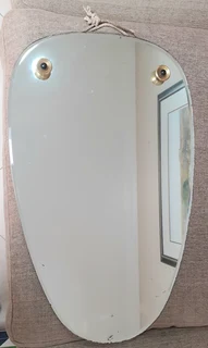 Vintage hanging wall mirror with beveled edge.