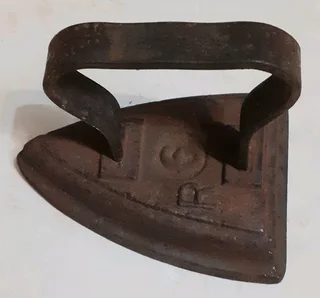 Vintage coal stove iron door stop.