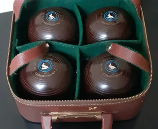 Set of 4 Henselite bowling balls in case.