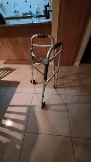 Fold up assisted walker.  Aluminum with wheels.